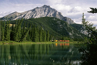 Canada's Banff Nat. Park, in Alberta. Train going up the Bow River; Cascade Mt. in bkgd. From the Marsh Loop Trail. [ref. to #166.040]