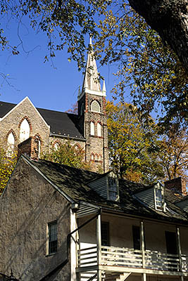 WV: Jefferson County, Potomac River Area, Harpers Ferry Nat. Hist. Park, Old Town, Church behind 19th C commercial bldg Fall colors [Ask for #194.053.]