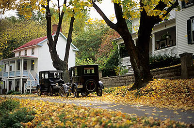 Antique Fords parked along side street in front of historic porched homes in the town of Harpers Ferry; fall leaves. Location: WV, Jefferson County, Potomac River Area, Harpers Ferry (town). [ref. to #194.059]