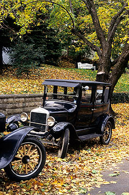 WV: Jefferson County, Potomac River Area, Harpers Ferry (town), Antique Fords parked along side street Fall leaves on road [Ask for #194.060.]