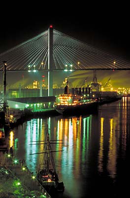 Savannah; Savannah River, new bridge, at night. Cargo ship; 3 masted schooner. Industrial plants in bkgd. Location: GA: Chatham County. [ref. to #196.020]