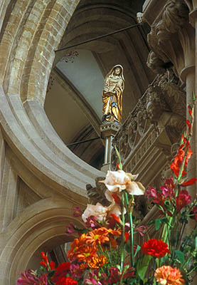 ENG: Somerset , The Mendip Hills, Wells, Wells Cathedral, The chancel; flowers on the carved stone pulpit, with a statue of the Virgin Mary behind [Ask for #201.048.]