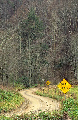 Gravel lane in farmland; deadend sign, one lane bridge sign. Winter. Location: NC, Madison County, The French Broad River Valley, Marshall, Little Pine Community. [ref. to #206.072]