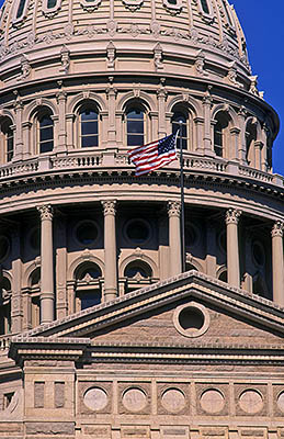 Pediment and dome over front entrance, with American flag. Location: TX, Travis County, Austin, State of Texas Capitol Building. [ref. to #208.039]