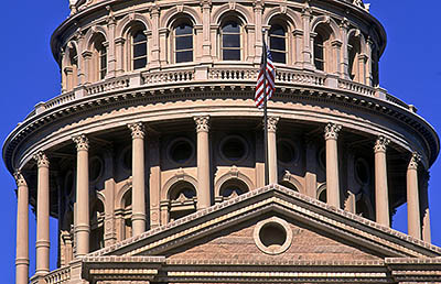 Pediment and dome over front entrance, with American flag. Location: TX, Travis County, Austin, State of Texas Capitol Building. [ref. to #208.040]