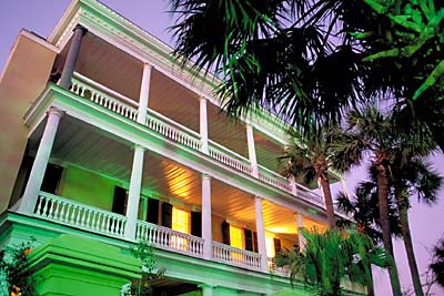 Charleston; The Battery -- Battery Park. Second and third story porches of this bed and breakfast inn; late dusk. (Street lamps cast a green light on house). Location: SC: Charleston County. [ref. to #211.145]