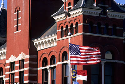 NC: New Hanover County, Cape Fear River Area, Wilmington, Wilmington Historic District, New Hanover County Courthouse. Flag in front of 2nd story tower [Ask for #211.153.]