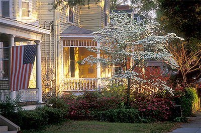 NC: New Hanover County, Cape Fear River Area, Wilmington, Wilmington Historic District, Porch on Victorian house; flag; dogwood, azeleas in bloom. [Ask for #211.165.]