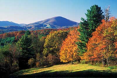 The Blue Ridge Parkway. View west along Blue Ridge; fall colors; from fields atop The Lump. Location: NC, Wilkes County, MP 264. [ref. to #214.122]