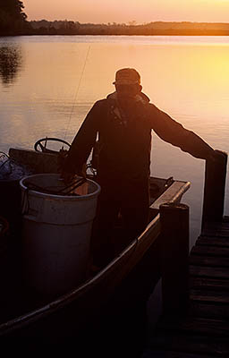 NC: Beaufort County, Pamlico Sound, Pungo River, River's mouth at Pimlico Sound, Fisherman Lee Morris launching his boat at sunrise. RELEASED [Ask for #224.285.]