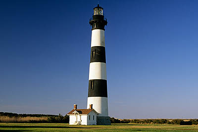 View of lighthouse from the west, showing service bldg. Location: NC, Dare County, The Outer Banks, Hatteras National Seashore, Bodie Island Lighthouse. [ref. to #224.454]