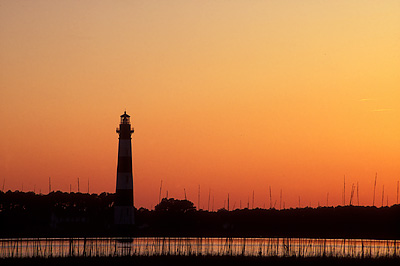 Lighthouse viewed over salt marsh at sunset. Location: NC, Dare County, The Outer Banks, Hatteras National Seashore, Bodie Island Lighthouse. [ref. to #224.461]