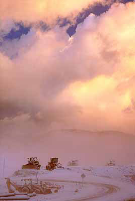 Sun rise in snow and fog, along US 19; construction equipment covered in snow. Location: NC, Madison County, North of Asheville, Mars Hill. [ref. to #228.889]