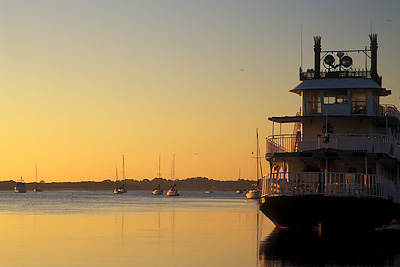 View over St. Augustine Harbor and the Matanzas River, from the Historic District; sunrise from docks, with excursion boat (rt) in the style of a riverboat. Location: FL, St. Johns County, St. Augustine, Municipal Yacht Pier. [ref. to #231.010]