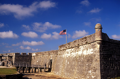 American flag (Civil War era) flying over south entrance, moat, and wall; viewed from east. Location: FL, St. Johns County, St. Augustine, Castillo de San Marcos Nat. Monument. [ref. to #231.040]