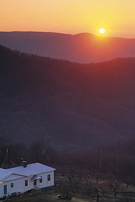 Sunrise viewed from The Blue Ridge; farmhouse and apple orchard (winter) in frgd. Location: NC, McDowell County, The Blue Ridge Parkway, Altapass Orchards (MP 329). [ref. to #232.005]