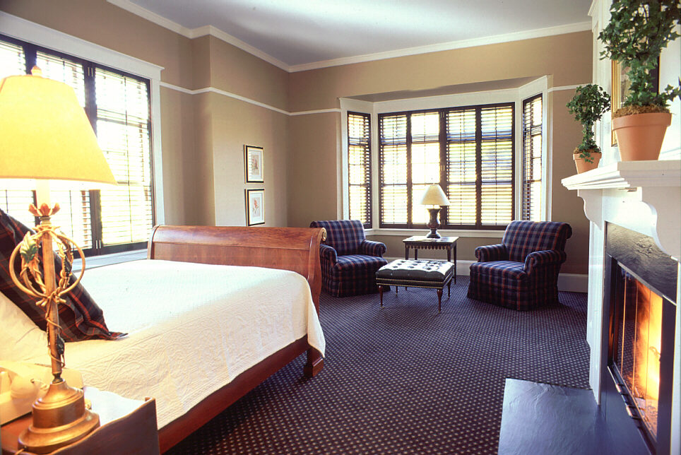 Smoky Mountain Room (#424); view from entry hall towards bed & sitting area, showing fireplace & shuttered windows. Location: NC, Buncombe County, Asheville, Richmond Hill Neighborhood, The Richmond Hill Inn. [ref. to #232.068]