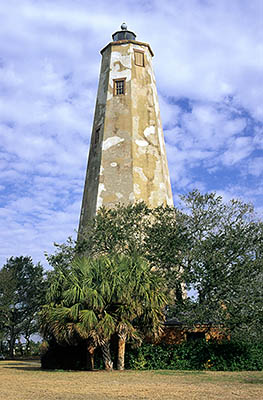 Old Baldy, viewed from the east, showing brick outbuilding (ctr) under palms & oaks. Location: NC, Brunswick County, Cape Fear Area, Bald Head Island, Bald Head I. Lighthouse (Old Baldy). [ref. to #233.023]