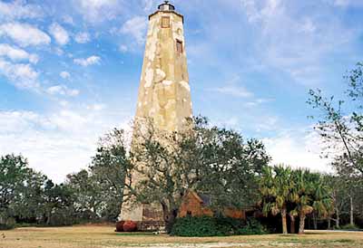 Old Baldy viewed from the east, showing brick outbuilding (ctr) under oaks. Location: NC, Brunswick County, Cape Fear Area, Bald Head Island, Bald Head I. Lighthouse (Old Baldy). [ref. to #233.025]