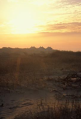 NC: Brunswick County, Cape Fear Area, Bald Head Island, Cape Fear, Sun rising over Captain Charlie's Station [Ask for #233.098.]