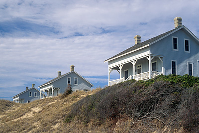 Capt. Charlie's Station, viewed from the beach dunes to the front (south) of the cabins. Location: NC, Brunswick County, Cape Fear Area, Bald Head Island, Captain Charlie's Station. [ref. to #233.137]