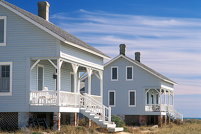 Capt. Charlie's Station, viewed from the beach dunes to the front (south) of the cabins. Location: NC, Brunswick County, Cape Fear Area, Bald Head Island, Captain Charlie's Station. [ref. to #233.140]