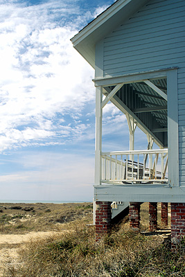 NC: Brunswick County, Cape Fear Area, Bald Head Island, Captain Charlie's Station, View past the porch of the easternmost cabin, towards the beach dunes and South Beach [Ask for #233.143.]