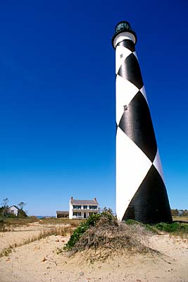 Cape Lookout Lighthouse, viewed from beach, with lightkeeper's cottage. Location: NC, Carteret County, Cape Lookout Nat. Seashore, Cape Lookout. [ref. to #233.482]