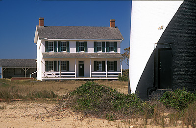 Lighthouse, with lightkeeper's cottage. Viewed from east. Location: NC, Carteret County, Cape Lookout Nat. Seashore, Cape Lookout, Cape Lookout Lighthouse. [ref. to #233.484]