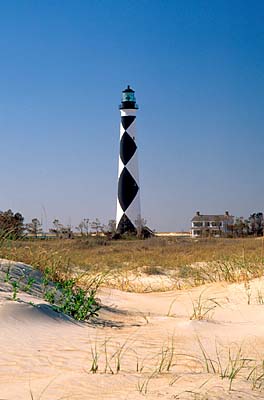 Cape Lookout Lighthouse, with lightkeeper's cottage. Viewed over ocean-side dunes. Location: NC, Carteret County, Cape Lookout Nat. Seashore, Cape Lookout [ref. to #233.495]