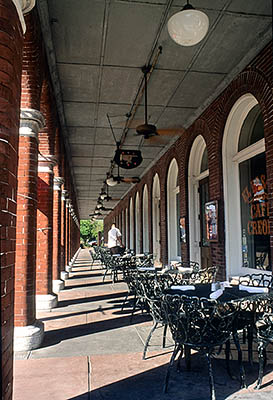 Waiter setting tables on the porch of El Pasaje, a 19th C. hotel still in use. Location: FL, Hillsborough County, Tampa, Ybor City. [ref. to #234.325]