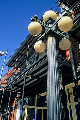 Tampa, Ybor City. 7th Avenue. 19th Cen. brick storefronts with balcony porches; by ball street lamp. Location: FL, Hillsborough County. [ref. to #234.337]