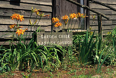 Garden Creek Baptist Church, a historic rural church now used as a campground church. Day lilies by front door. Location: NC, Wilkes County, The Blue Ridge, Stone Mountain State Park. [ref. to #236.057]