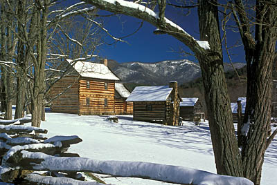 Log farmhouse viewed over split rail fence, in snow. Location: NC, Buncombe County, The Blue Ridge Mountains, Weaverville Area, Zebulon Vance Birthplace. [ref. to #237.045]