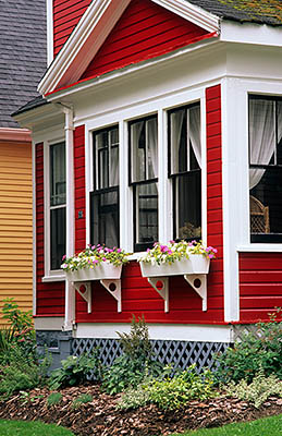 PE: Queens County, Hillsborough River Area, Charlottetown, Restored Victorian-era house, painted bright red, with fall flowers in planters & beds. [Ask for #240.009.]