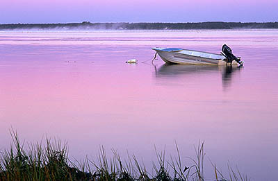 PE: Queens County, Anne's Land Area, Winter Bay, at Corran Ban Comm., Sunrise over the bay; sunrise colors reflected on the water; small fishing boat anchored in the bay. [Ask for #240.027.]