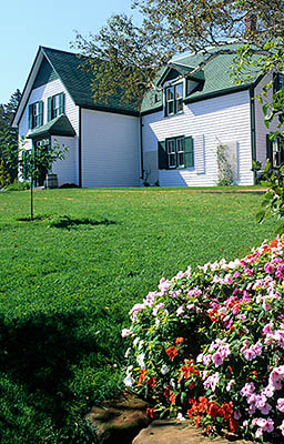 PE: Queens County, Anne's Land Area, House of Green Gables, PEI Nat. Park, Side view of the house, with autumn flowers. [Ask for #240.073.]