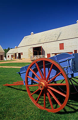 PE: Queens County, Anne's Land Area, House of Green Gables, PEI Nat. Park, View over small, brightly painted cart towards shingle-sided barn [Ask for #240.078.]