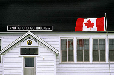 PE: Prince County, North By Northwest Area, O'Leary, Small rural schoolhouse, now a civic center, flying a Canadian flag. [Ask for #240.234.]