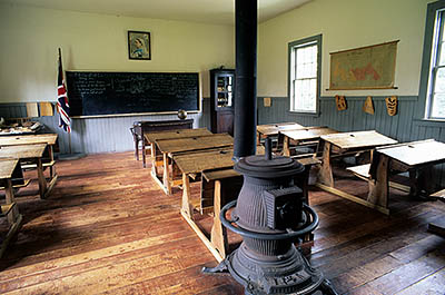 PE: Queens County, Hills & Harbours Area, Orwell Center, a recreated village, Orwell village school; interior; furnished as in late 19th C. with pot bellied stove, Union Jack and portrait of Queen Victoria. [Ask for #240.265.]