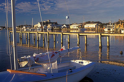 NC: Hyde County, The Outer Banks, Ocracoke Island, Ocracoke Village, View across harbor (known as Silver Lake) towards village; small sailboat in frgd [Ask for #241.328.]