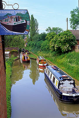 ENG: Thames & Chilterns Region, Oxfordshire, Upper Cherwell Valley, Banbury, Cropredy, View of the Oxford Canal in the center of the village, with a wood painted sign, "Cropredy Wharf" [Ask for #243.097.]