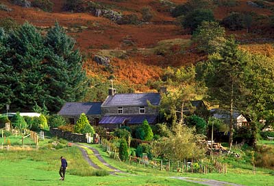 Farm above village; boy playing soccer by slate farmhouse. Location: WAL, Gwynedd County, Snowdonia National Park, Beddgelert area, Nantmor. [ref. to #248.487]