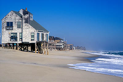 NC: Dare County, The Outer Banks, Hatteras Island, Rodanthe, Stilt-elevated vacation homes overlooking surf, some damaged or destroyed by sea encroachment. [Ask for #249.076.]