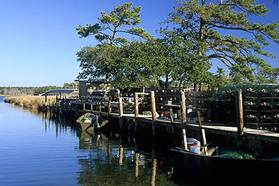 Crab traps line a dock. Location: NC, Dare County, The Outer Banks, Nags Head & Kitty Hawk, on Bodie Island, Colington Island. [ref. to #249.099]