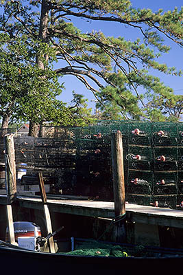 Crab traps line a dock. Location: NC, Dare County, The Outer Banks, Nags Head & Kitty Hawk, on Bodie Island, Colington Island. [ref. to #249.100]