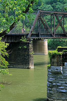 WV: Jefferson County, Potomac River Area, Harpers Ferry Nat. Hist. Park, Old Town, The Appalachian Trail crossing the Potomac River on a railroad trestle; Maryland Cliffs form a backdrop [Ask for #251.289.]