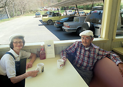 Long time employees Dixie Hughes (68, left) and Bayless Crisp (80, right) enjoy a cup of coffee in the dining room. Verbal PR and MR. Location: NC, Swain County, Tuckaseegee Valley, Bryson City, Nab-Bers Drive-In. [ref. to #255.008]