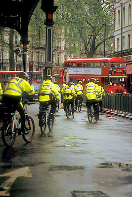 "Bobbies on bicycles two-by-two"; police bicycle patrol leaves Victoria Station after morning roll call. Location: ENG, Greater London , City of Westminster, Victoria Station, Station Exterior. [ref. to #256.102]