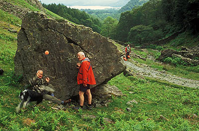 Search and Rescue Dogs Assoc. (Lake District) training session. Search dog trainee Fly, w. handler Mike Hadwin, plays w. toy after finding "body" Geoff Faulkner. Location: ENG, Cumbria , Lakes District N.P., Borrowdale Area, Broadstack Gil (NT). [ref. to #259.157]